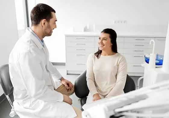 Dentist and patient talking in dental office